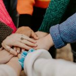 Hands joining together to signify teamwork.